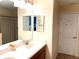 Double vanity bathroom with modern fixtures and a mirror at 1402 Wexford Way, Davenport, FL 33896