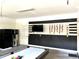 Game room features a pool table, large TV, and stylish wall decor at 1402 Wexford Way, Davenport, FL 33896