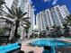 Resort-style pool with lounge chairs and surrounding buildings at 7395 Universal Blvd # 904, Orlando, FL 32819