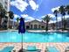 Inviting community pool with surrounding lounge chairs at 7395 Universal Blvd # 904, Orlando, FL 32819