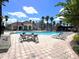 Community pool with ample lounge chairs and a nearby seating area at 7395 Universal Blvd # 904, Orlando, FL 32819