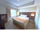 Spacious bedroom with king-size bed and large window offering natural light at 7395 Universal Blvd # 904, Orlando, FL 32819