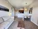Bright living room with open floor plan, featuring a comfortable sofa and dining area at 7395 Universal Blvd # 904, Orlando, FL 32819