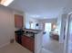 Well-equipped kitchen with dark wood cabinets and black appliances at 7395 Universal Blvd # 904, Orlando, FL 32819