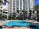 Community pool with plenty of lounge chairs at 7395 Universal Blvd # 904, Orlando, FL 32819