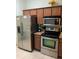 Kitchen features stainless steel appliances and wood cabinets at 3001 Calabria Ave, Davenport, FL 33897