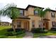 Two-story townhome with landscaping and walkway at 3001 Calabria Ave, Davenport, FL 33897