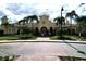 Community building with palm trees and brick driveway at 5002 Tideview Cir # 3, Orlando, FL 32819