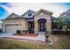 House exterior with stone accents and a landscaped walkway at 1004 Country Oaks Ln, Lakeland, FL 33810