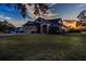 One-story home with attached garage and spacious lawn at sunset at 1004 Country Oaks Ln, Lakeland, FL 33810