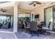 Covered patio with wicker furniture and dining set, ideal for outdoor entertaining at 1004 Country Oaks Ln, Lakeland, FL 33810