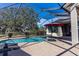 Inviting pool area with covered patio and lounge chairs at 1004 Country Oaks Ln, Lakeland, FL 33810