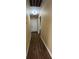 Long hallway with wood flooring and neutral walls at 1022 N Swindell Ave, Lakeland, FL 33805