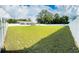 Large grassy backyard with a white privacy fence at 16446 Se 88Th Ave, Summerfield, FL 34491