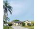Single-story home with solar panels and a palm tree in the front yard at 2103 Pimlico St, Orlando, FL 32822
