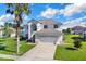 Two-story house with a palm tree and driveway at 4431 Canopy Ct, Kissimmee, FL 34758