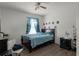 Cozy bedroom with a double bed, ceiling fan, and wood floors at 7878 Tanbier Dr, Orlando, FL 32818