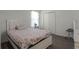 Bedroom with a floral bedspread and double door closet at 7878 Tanbier Dr, Orlando, FL 32818