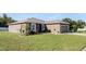Side view of the house showcasing a large grassy yard at 7878 Tanbier Dr, Orlando, FL 32818
