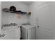 Laundry room with washer, dryer, and shelving at 7878 Tanbier Dr, Orlando, FL 32818