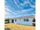 Rear view of the house showcasing a sliding glass door and grassy yard at 9115 Se 88Th St, Ocala, FL 34472