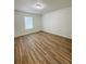 Bright bedroom featuring hardwood floors and large window at 9115 Se 88Th St, Ocala, FL 34472