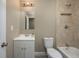 Bathroom with white vanity, tile shower and tub at 13 E 8Th St, Frostproof, FL 33843