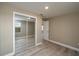 Bedroom with mirrored closet and wood-look floors at 13 E 8Th St, Frostproof, FL 33843