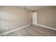 Simple bedroom with neutral walls and wood-look floors at 13 E 8Th St, Frostproof, FL 33843