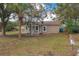 Newly renovated house with teal front door, and a porch at 13 E 8Th St, Frostproof, FL 33843