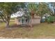 Newly renovated house with teal front door, and a porch at 13 E 8Th St, Frostproof, FL 33843