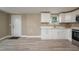 Modern kitchen with white cabinets and quartz countertops at 13 E 8Th St, Frostproof, FL 33843