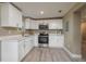 Modern kitchen with white cabinets and stainless steel appliances at 13 E 8Th St, Frostproof, FL 33843