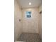 Large shower with tile surround and hexagon floor at 13 E 8Th St, Frostproof, FL 33843