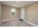 Bright spare bedroom with wood-look floors and exterior access at 13 E 8Th St, Frostproof, FL 33843