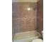 Bathroom with shower/tub combo and tile surround at 6274 Whispering Way # 130, Orlando, FL 32807