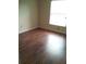 Bedroom with wood-look flooring and window at 6274 Whispering Way # 130, Orlando, FL 32807