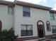Two-story building exterior with red trim at 6274 Whispering Way # 130, Orlando, FL 32807