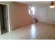 Open living area with tile floors, staircase, and access to other rooms at 6274 Whispering Way # 130, Orlando, FL 32807