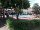 Community pool with surrounding patio and landscaping at 6274 Whispering Way # 130, Orlando, FL 32807
