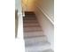 Carpeted stairs with handrail at 6274 Whispering Way # 130, Orlando, FL 32807