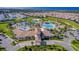 Aerial view of community center with pool and surrounding neighborhood at 1502 Moon Valley Dr, Davenport, FL 33896