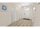 View of a light-filled hallway with tile floors and access to multiple rooms at 9098 Hazard St, Davenport, FL 33896
