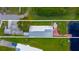 An aerial view showcasing a home's layout, backyard, and dock access to a lake at 3198 Tohopekaliga Dr, Saint Cloud, FL 34772