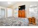 Main bedroom with king-size bed, wood furniture, and a TV at 3198 Tohopekaliga Dr, Saint Cloud, FL 34772