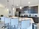 Modern kitchen with island, white quartz countertops and dark cabinets at 580 Pebble Beach Dr, Davenport, FL 33896