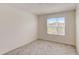 Well lit bedroom with window and neutral carpet at 1688 Tropical Palms Cir, Kissimmee, FL 34747