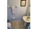 Clean bathroom with pedestal sink, toilet and tiled floor at 2605 Emerald Island Blvd, Kissimmee, FL 34747