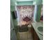 Small bathroom with shower and decorative shower curtain at 2605 Emerald Island Blvd, Kissimmee, FL 34747