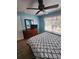 Bedroom with queen bed, ceiling fan, dresser, and window at 2605 Emerald Island Blvd, Kissimmee, FL 34747
